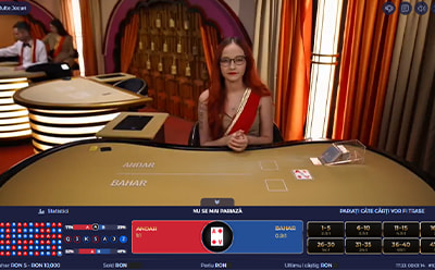 Crupier la masa Andar Bahar live care așteaptă pariurile jucătorilor.