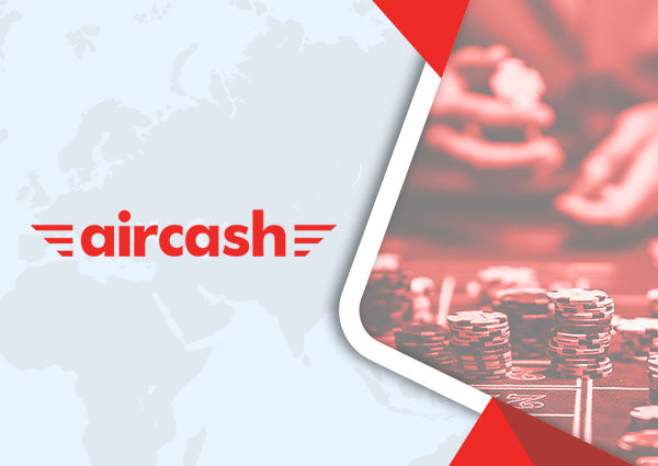 Jetoane de cazinou pe o masă de joc și logo-ul companiei Aircash